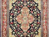 a black and red rug with an ornate design