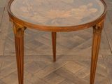 a small table with a glass top on a wooden floor