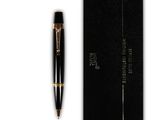 a black pen sitting next to a black box on top of a white surface