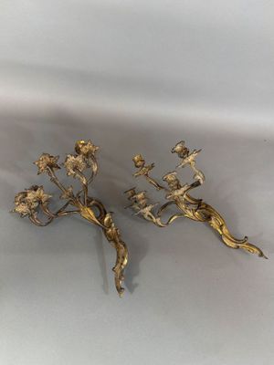 pair of gold plated candlesticks with flowers and leaves
