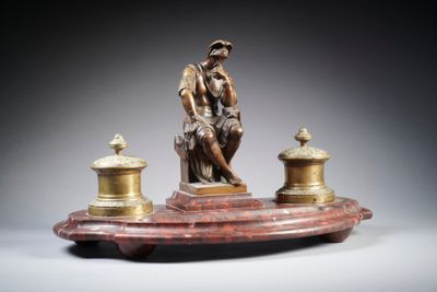 an image of a statue of a man sitting on top of a table