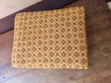 an image of a chair cushion on a wooden floor