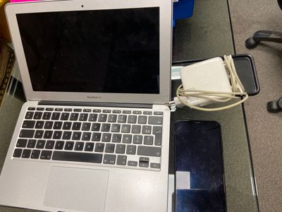 a laptop computer sitting on top of a glass table