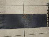 a picture of a metal shelf with a yellow piece of paper in it