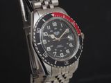 un gros plan d'une montre-bracelet avec une lunette rouge