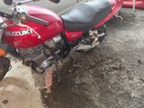 a red motorcycle that is parked on the side of the road