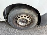 a white car with a flat tire on the street