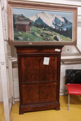 une photo d'un tableau accroché au mur à côté d'une chaise rouge