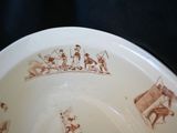 a brown and white plate with a picture of people on it