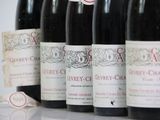 several bottles of wine are lined up on a table