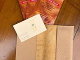 three packets of tea sitting on a table next to a book