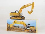 a yellow toy excavator sitting on top of a box