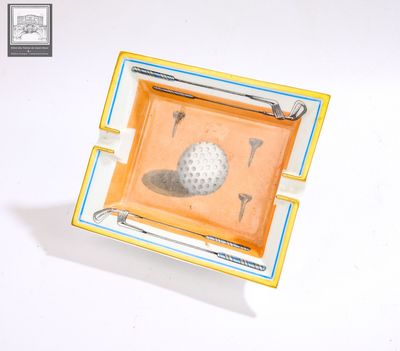 a small tray with a golf ball and tees on it