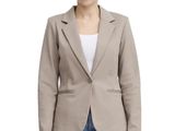 the woman is wearing a jacket and jeans and a white t - shirt