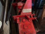 a red machine that is sitting in a garage