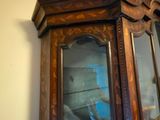 a wooden cabinet with a glass door on the wall