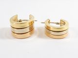 two tone gold hoop earrings with a white background