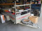 a truck with a trailer attached to it in a garage
