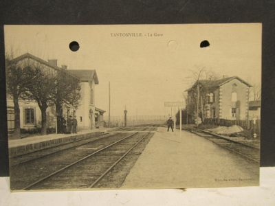 an old photo of a train station in the middle of the day