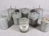 several old tin cans are lined up on a white surface