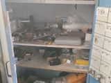 a blue cabinet with lots of clutter in it