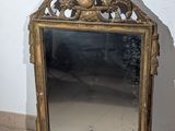a mirror that is sitting on the floor in front of a wall
