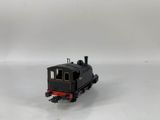 a small toy train sitting on a white surface