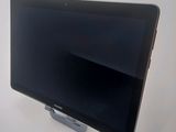 a tablet computer sitting on a stand on a table