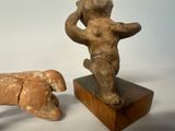 two figurines of a man and a dog on a table