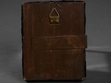 a small brown book with a metal lock on it