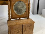 a small wooden box with a mirror on top of it
