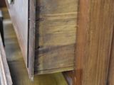 a wooden dresser with two drawers and a clock on top