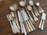 a lot of silver spoons and spoons on a table