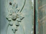 a close up of a metal door with a decorative design