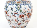 a white vase with a red and blue design on it