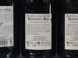 three bottles of wine sitting on top of a table next to each other