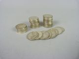 a pile of coins sitting on a table next to a pile of coins