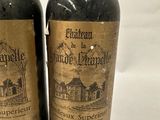 two bottles of wine sitting next to each other on a table