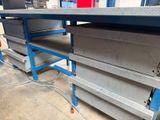 a metal workbench that has a bunch of drawers on it