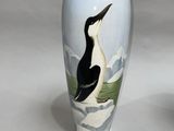 two vases with birds painted on them sitting on a table
