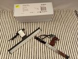 a box with a pen and a pair of scissors on the floor