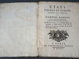 an open book with a picture of a coat of arms on it