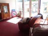 a living room with a couch, chair, television and a large window
