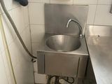 a bathroom with a sink and a hose in it