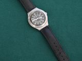 a close up of a wrist watch on a green surface