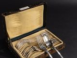 a wooden box with silverware in it on a black surface