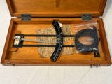 a wooden box with a pair of scissors in it