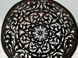 an antique cast iron frying pan with a decorative design on it