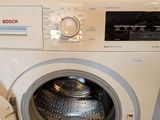 a washing machine that is sitting next to a washer