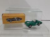an image of a green toy car and a box on a table